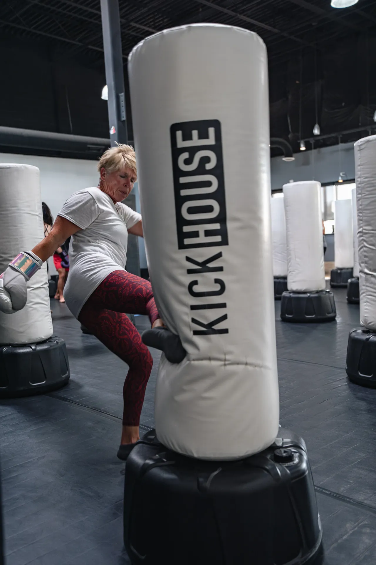 A KickHouse member throwing a knee on the heavy bag